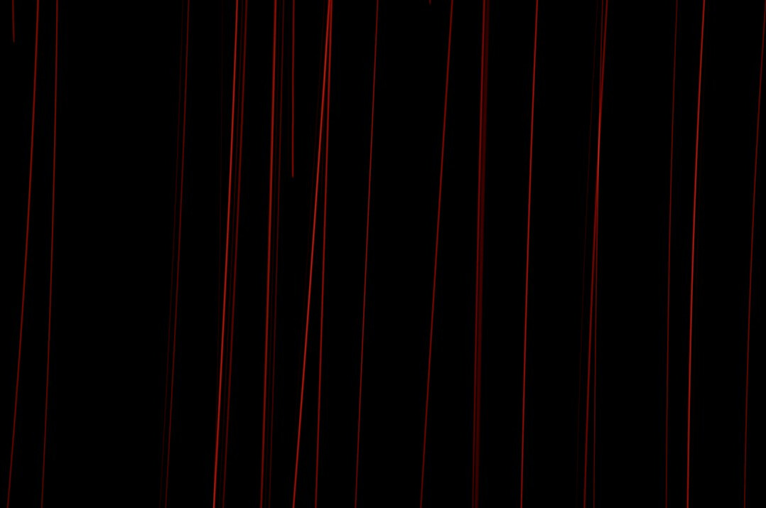Empty theatre stage with red curtains and dramatic spotlight