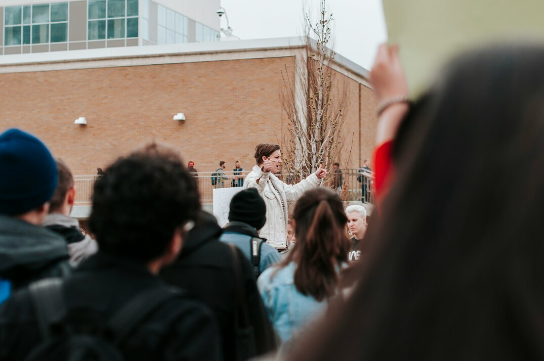 Close-up of a student giving a speech to a small audience